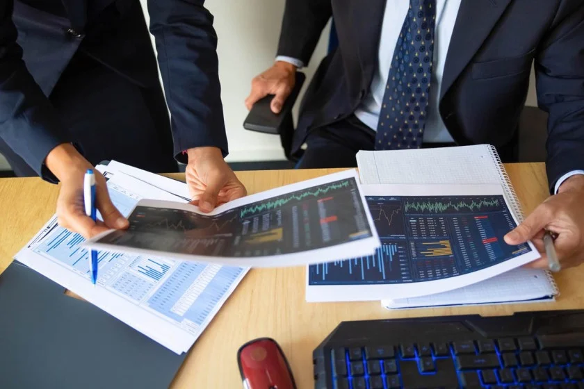 Business team reviewing financial reports for Corporate Tax in UAE.
