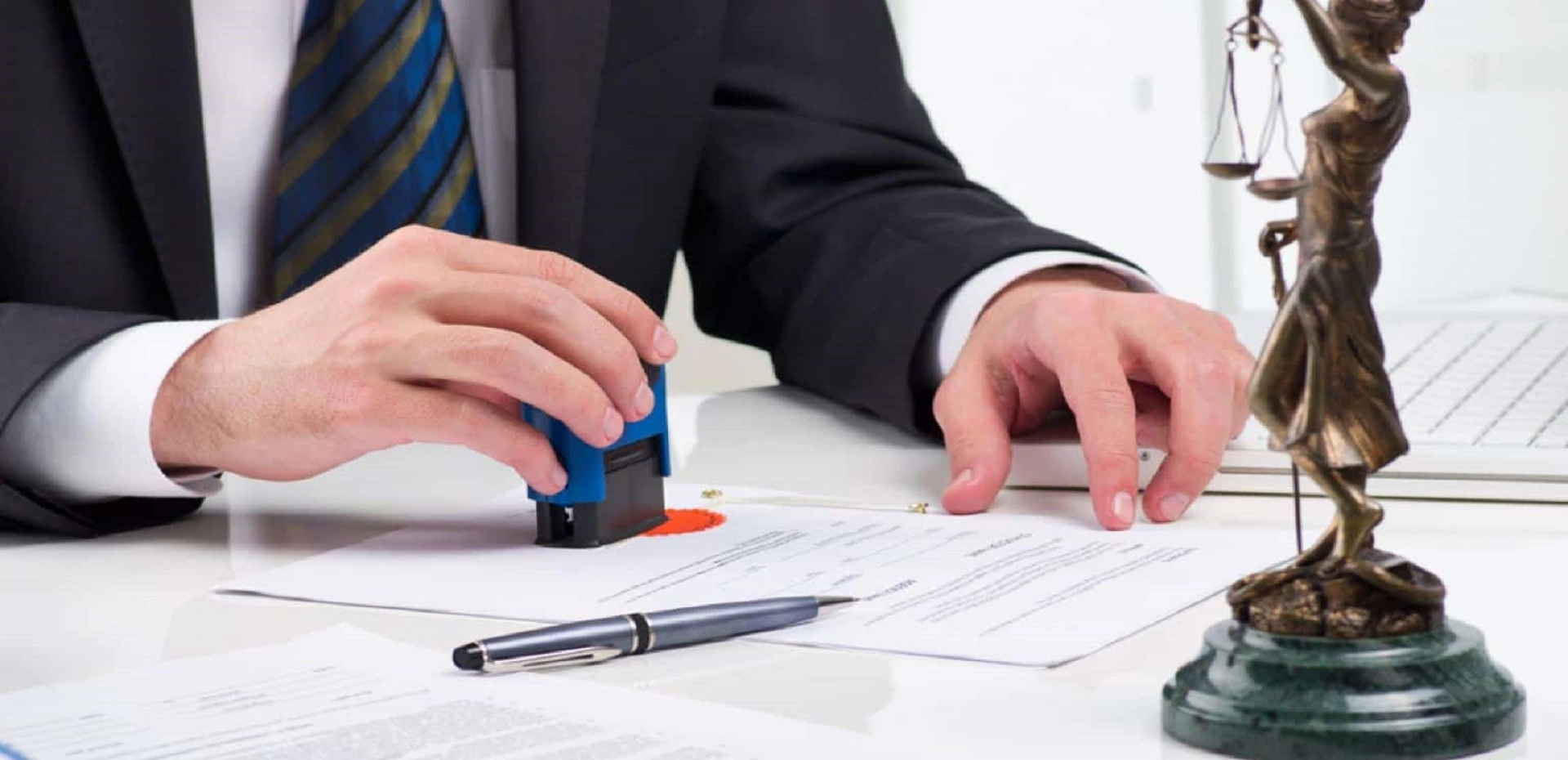 Businessman stamping documents for Dubai Free Zone company formation.